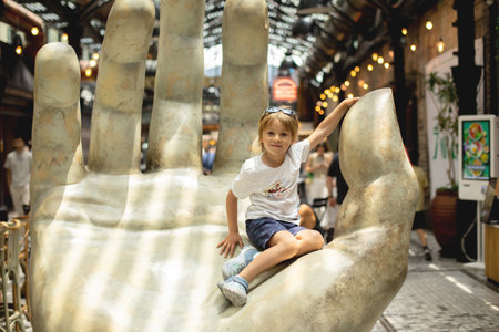Family with kids, enjoying the Sarona Market in Tel Aviv, Israel, trying the foodの写真素材