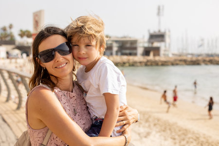 Mother and child, family enjoying the seaside views in Tel Aviv on a hot summer day, afternoonの写真素材