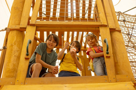 Happy children, boys, playing on playground in Tel Aviv, israel on a hot summer dayの写真素材