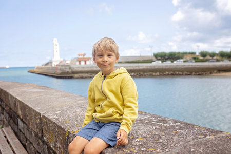 Family, visiting small town in France, Saint Jean de Luz, during summer vacation, traveling with children in Europeの写真素材