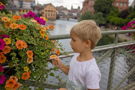 Beautiful family with children, boys, visiting Strasbourg in France during summer vacationの写真素材