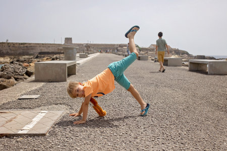 Family with children, visiting the most south point of Europe, Tarifa in Spain