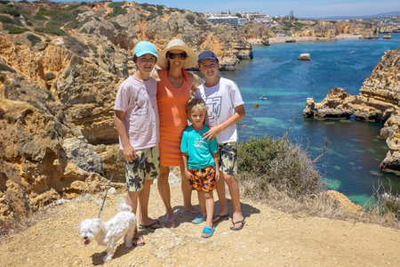Children, enjoying Benagil, Portugal. Benagil Cave inside Algar de Benagil, famous sea cave in Algarve coast, Lagoa. Happy family on a canoe tripの写真素材