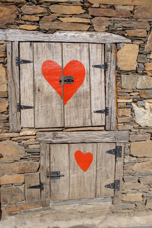 Beautiful medieval village Talasnal in Lousa, Portugal on a beautiful day. Child playing on the street of the village with his pet dog, reading bookの写真素材