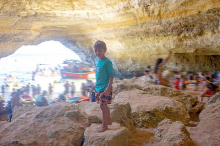 Children, enjoying Benagil, Portugal. Benagil Cave inside Algar de Benagil, famous sea cave in Algarve coast, Lagoa. Happy family on a canoe tripの写真素材