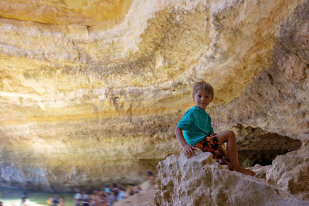 Children, enjoying Benagil, Portugal. Benagil Cave inside Algar de Benagil, famous sea cave in Algarve coast, Lagoa. Happy family on a canoe tripの写真素材