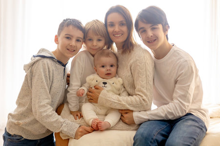 Happy family, newborn baby and older brothers, mom at home on Christmasの写真素材