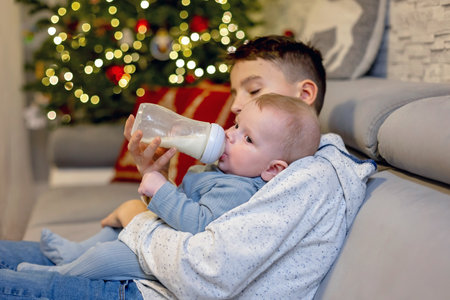 Happy family, newborn baby and older brothers, mom at home on Christmasの写真素材