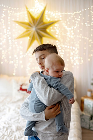 Happy family, newborn baby and older brothers, mom at home on Christmas