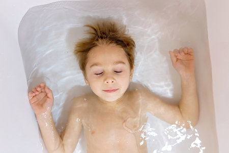 Cute baby boy, child, in bath, smiling