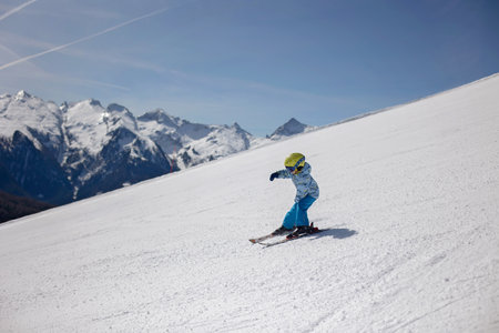 Happy family, enjoying ski holiday with children, sunny beautiful weather outdoorsの写真素材