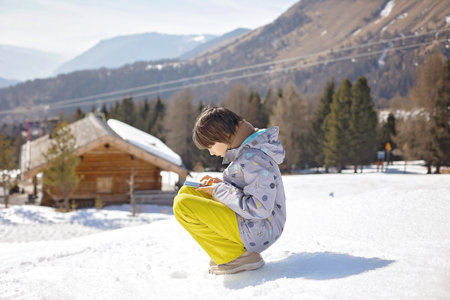 Happy family, enjoying ski holiday with children, sunny beautiful weather outdoorsの写真素材