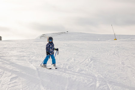 Children and adults, happy family in winter clothing at ski vacation, skiing, wintertime