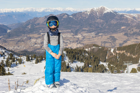 Children and adults, happy family in winter clothing at ski vacation, skiing, wintertimeの写真素材