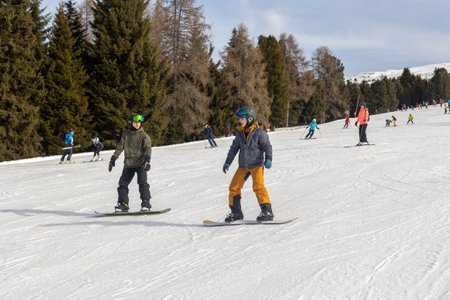 Children and adults, happy family in winter clothing at ski vacation, skiing, wintertime