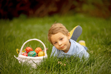Cute preschool child, whipping his sister on Easter with twig, braided whip made from pussy willow,...