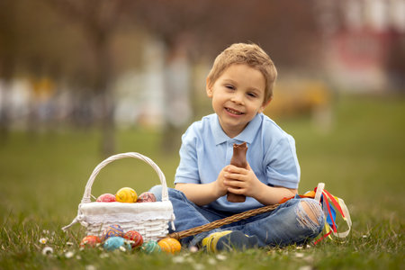Cute preschool child, whipping his sister on Easter with twig, braided whip made from pussy willow,...