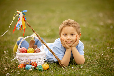 Cute preschool child, whipping his sister on Easter with twig, braided whip made from pussy willow, traditional symbol of Czech Easter used for whipping girls and womenの写真素材