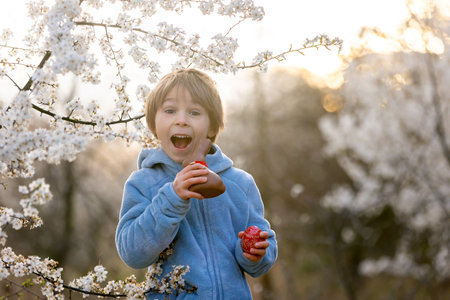 Beautiful blond child, boy, holding twig, braided whip made from pussy willow, traditional symbol of...
