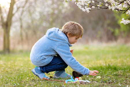 Beautiful blond child, boy, holding twig, braided whip made from pussy willow, traditional symbol of...