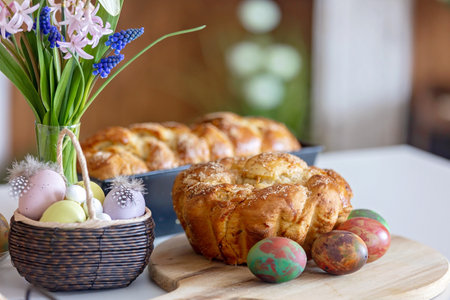 Cute preschool child, boy, holding sweet brioche bun for Easter, traditional swee bread baked with almonds, nuts and sugar, homeの写真素材