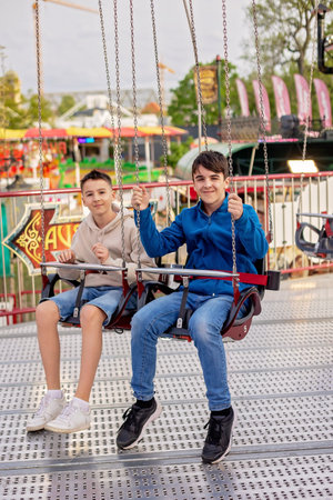 Happy children, enjoying a day in amusement park  with familyの写真素材