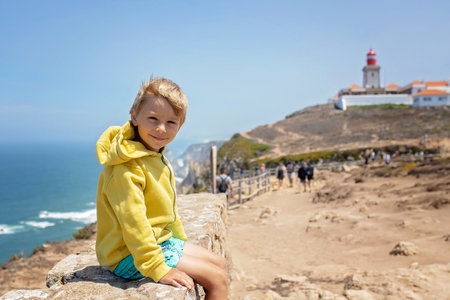 Family with children, siblings, visiting the most west point of Europe, Cabo Da Roca, during family vacation summertime in Portugalの写真素材