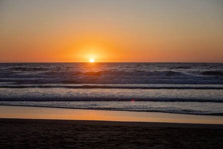 Happy children, boys, playing on the beach on sunset, kid cover in sand, smiling, laughing, enjoying some funの写真素材