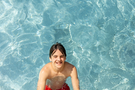 Cute child, boy in water park, having fun summertime together with brothersの写真素材