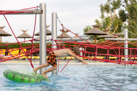 Cute child, boy in water park, having fun summertime together with brothersの写真素材