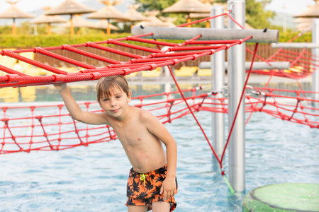 Cute child, boy in water park, having fun summertime together with brothersの写真素材