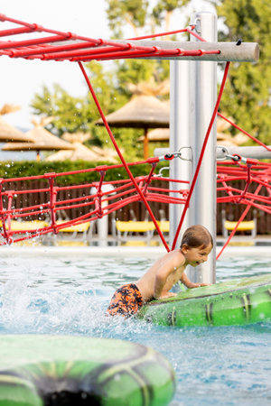 Cute child, boy in water park, having fun summertime together with brothersの写真素材