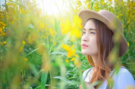 woman stands happily in the flower garden. sunhempの写真素材