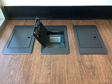 Floor plug,pop up plug in metal cover installed in wooden floor.Electrical work.System engineering.の写真素材