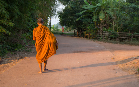 Buddha monk walk in the morning for receive food from Buddhism.の写真素材
