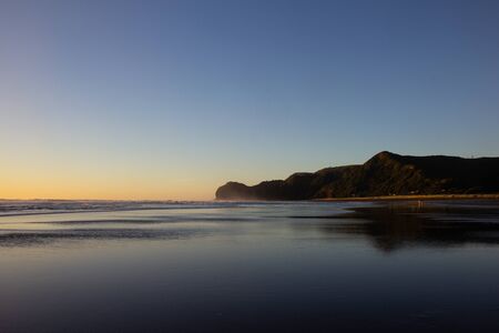 sunset at Piha beach, North island of New Zealandの写真素材