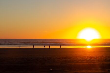 sunset at Piha beach, North island of New Zealandの写真素材