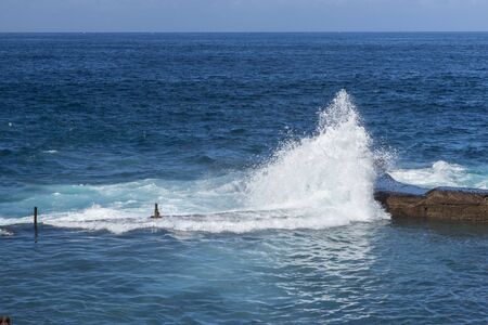 wave splashes on stones at Tenerife island, Spain, Canary islandsの写真素材