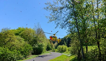 OBERBACH, WILDFLECKEN, BAVARIA, GERMANY - APRIL 30, 2019, ADAC rescue helicopter Christoph 28 starts on its way to hospital after a motorcycle accident.のeditorial素材