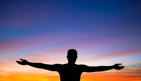 a silhouette of a man on background of beautiful sunset の写真素材
