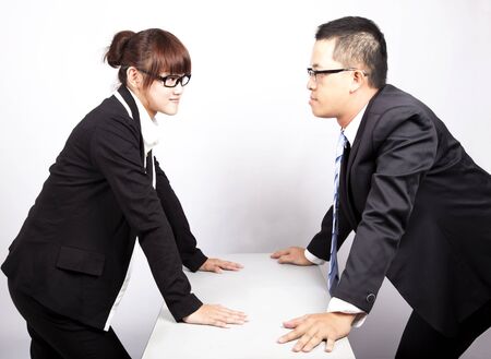 businessman and woman war in officeの写真素材