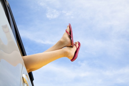 young woman's legs and summer road trip concept