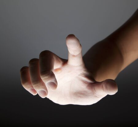 hand touching in the darkの写真素材