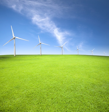 Wind turbines in an green field with cloud backgroundの写真素材