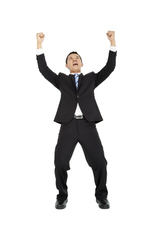 Excited young  business man with arms raised in success の写真素材