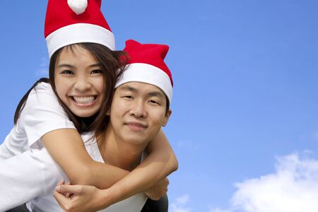 Young happy asian couple in Christmas hatsの写真素材