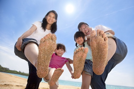 happy asian family enjoy summer time on the beachの写真素材