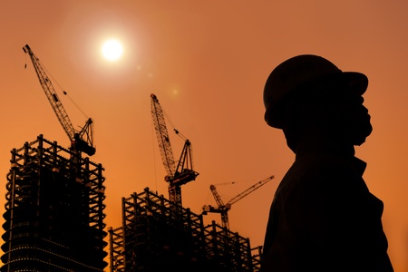 The Silhouette of Construction workers with sunsetの写真素材