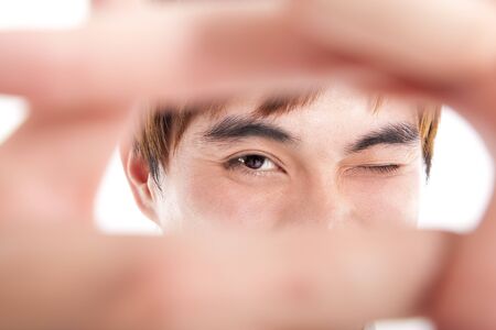 young man showing thinking outside the square conceptの写真素材