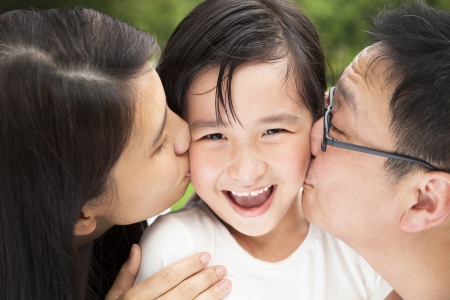 happy asian family in kissingの写真素材